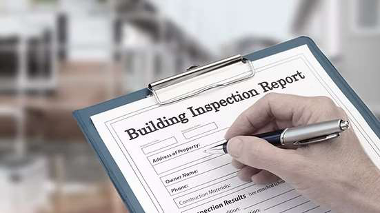 Building inspection report on clipboard
