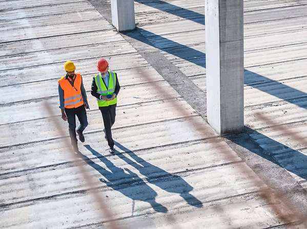 Workers walking across a large floor
